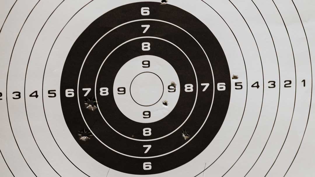 Photo closeup of a shooting target with holes in it